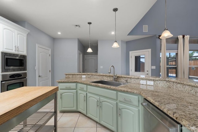 3222 Princess St, Edinburg, TX 78539 - kitchen with appliances with stainless steel finishes, a sink, hanging light fixtures, light tile patterned floors, and white cabinetry