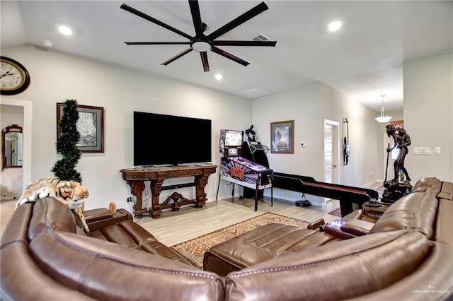 living room featuring hardwood / wood-style floors, ceiling fan, and lofted ceiling