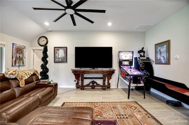 living room featuring hardwood / wood-style floors, ceiling fan, and lofted ceiling