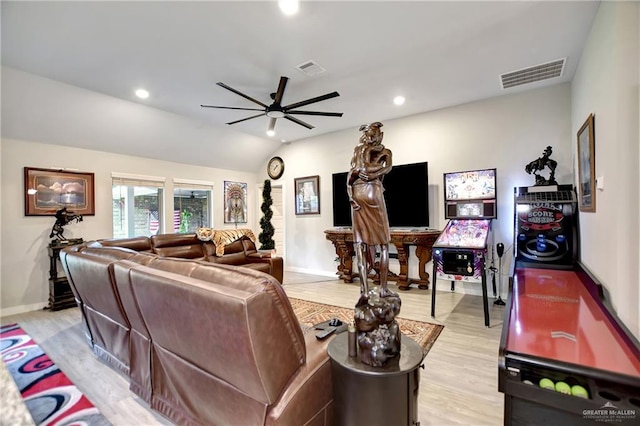 living room featuring ceiling fan, light hardwood / wood-style flooring, and lofted ceiling