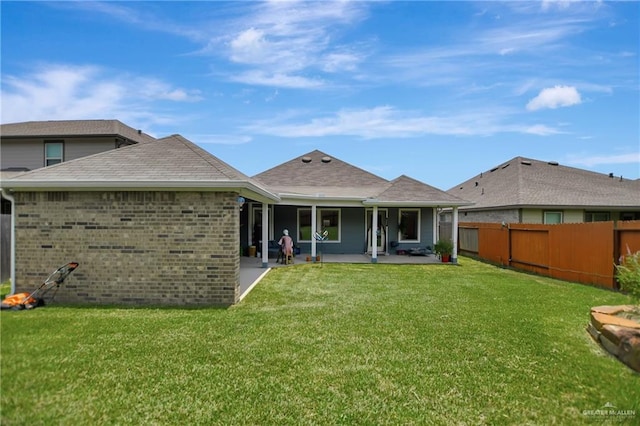 back of property featuring a yard and a patio