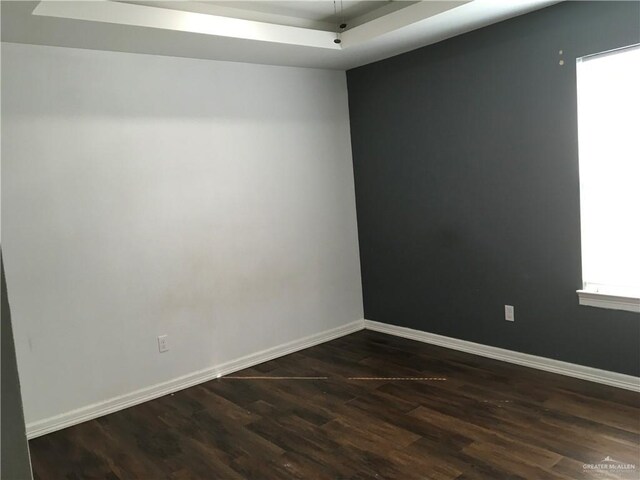 spare room featuring dark hardwood / wood-style floors