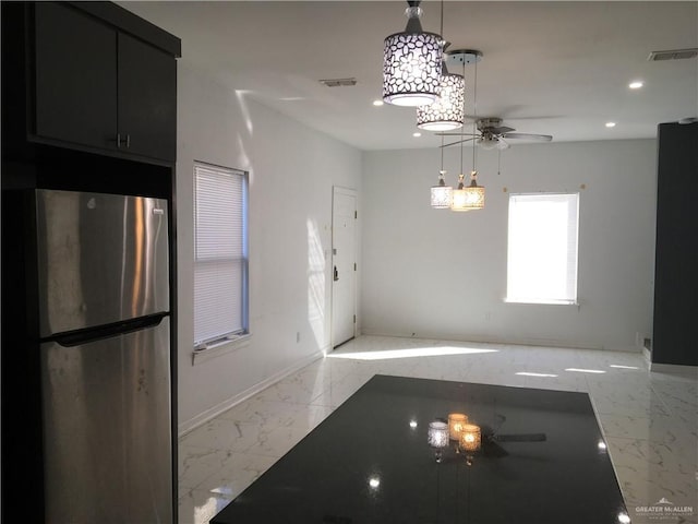 unfurnished dining area featuring ceiling fan