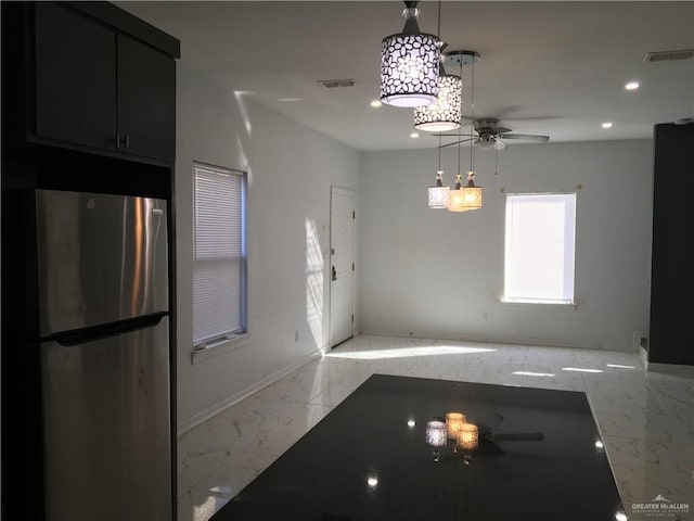 unfurnished dining area with ceiling fan