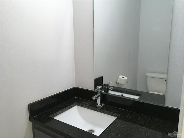 bathroom featuring vanity and toilet