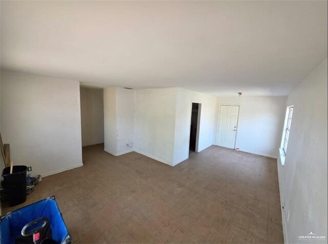 1001 S 5th Ave, Edinburg, TX 78539 - unfurnished living room with baseboards