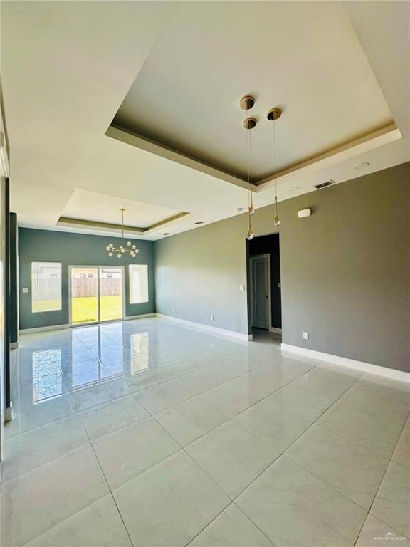 2802 Garman St, Edinburg, TX 78542 - unfurnished room with a tray ceiling, a chandelier, baseboards, and light tile patterned floors