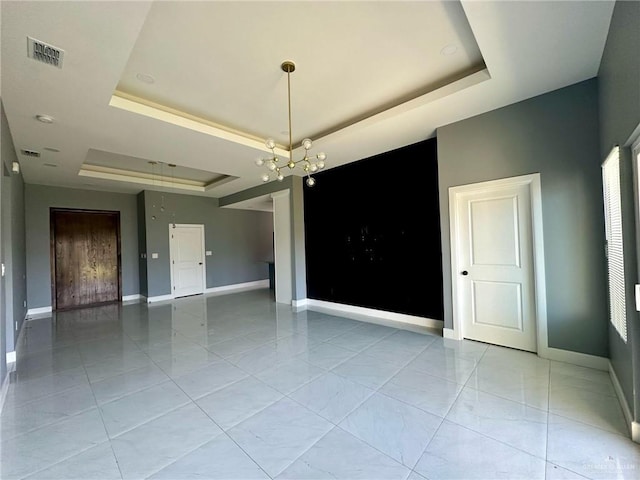 2802 Garman St, Edinburg, TX 78542 - spare room with a raised ceiling, baseboards, and a chandelier