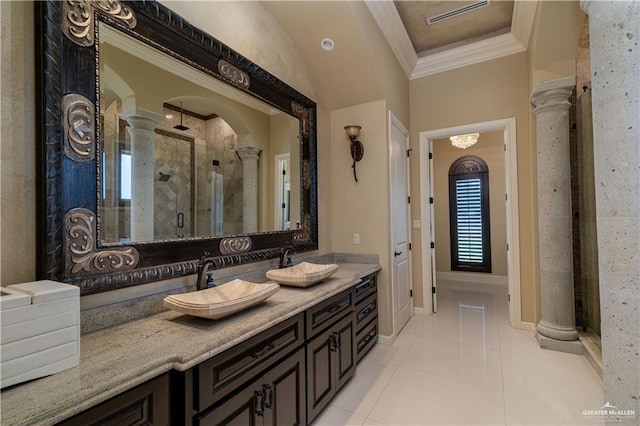 bathroom featuring decorative columns, tile patterned flooring, a shower with shower door, vanity, and crown molding