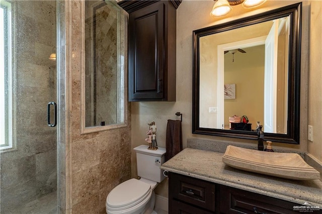 bathroom with toilet, an enclosed shower, and vanity