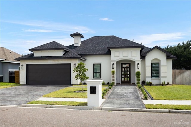 view of front of property featuring a front yard and a garage