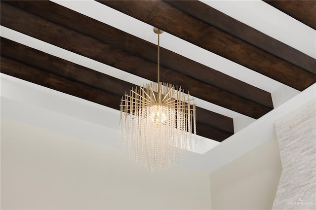 interior details featuring beamed ceiling and an inviting chandelier