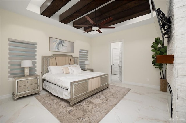 bedroom with ceiling fan and beamed ceiling