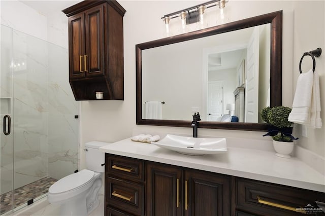 bathroom featuring vanity, toilet, and an enclosed shower