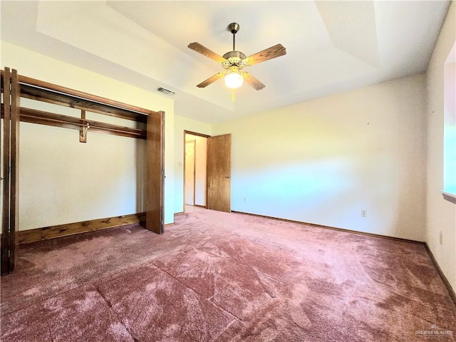2028 Loker St, Mission, TX 78572 - unfurnished bedroom with carpet, a tray ceiling, a closet, baseboards, and a ceiling fan