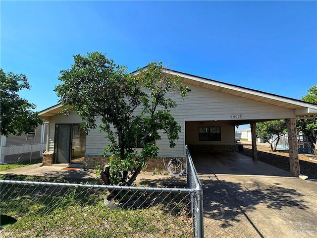 2028 Loker St, Mission, TX 78572 - view of front of house featuring concrete driveway, fence, and a carport