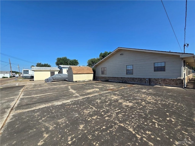 2028 Loker St, Mission, TX 78572 - view of home's exterior featuring uncovered parking, a storage shed, and an outdoor structure