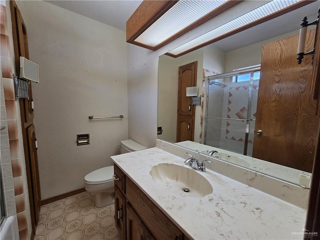 2028 Loker St, Mission, TX 78572 - bathroom featuring a shower with door, toilet, vanity, and baseboards