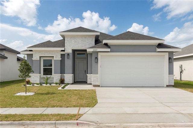 prairie-style house with a garage and a front lawn