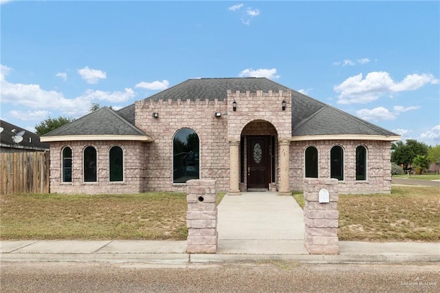 french country inspired facade with a front yard