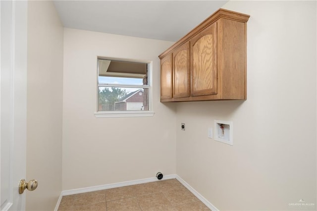 laundry room featuring hookup for an electric dryer, cabinets, light tile patterned floors, and washer hookup