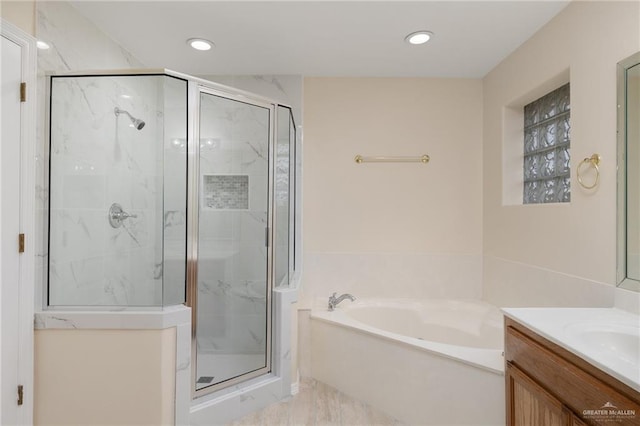 bathroom with vanity and separate shower and tub