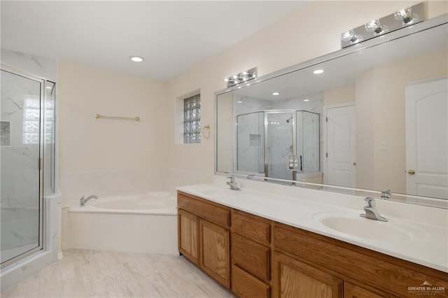 bathroom featuring vanity and independent shower and bath