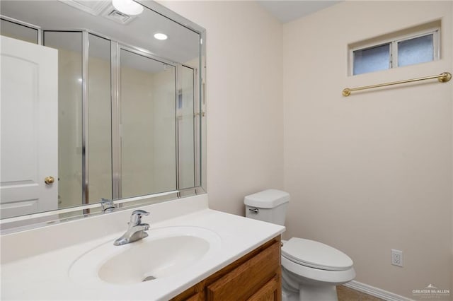 bathroom featuring vanity, toilet, and a shower with door