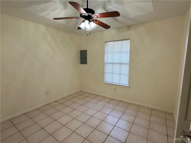 unfurnished room featuring ceiling fan, electric panel, baseboards, and light tile patterned flooring