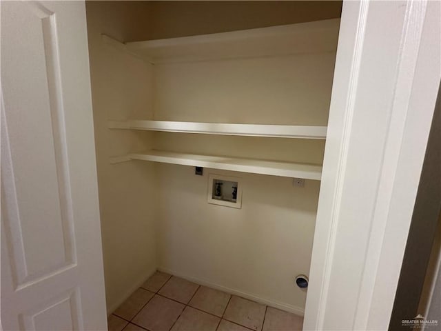 laundry area featuring hookup for a washing machine, laundry area, and light tile patterned floors