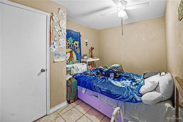 tiled bedroom with ceiling fan