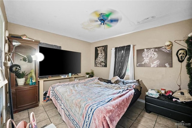 bedroom featuring light tile patterned floors and ceiling fan