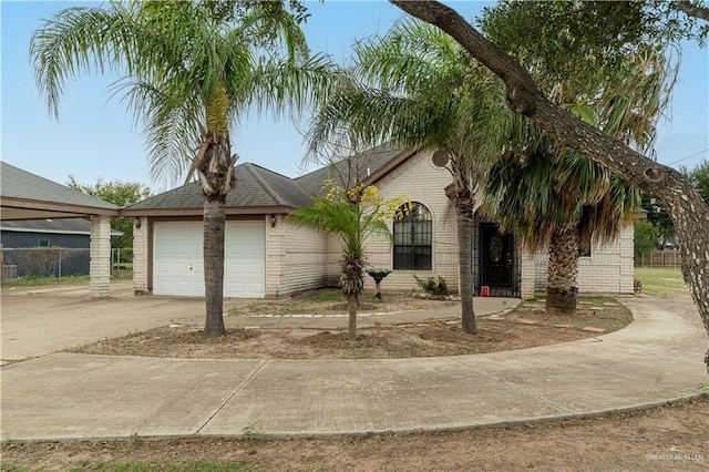 1305 Opal St, Penitas, TX 78576 - view of front of property with brick siding, driveway, and a garage