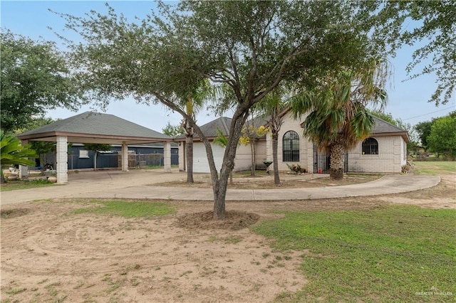 1305 Opal St, Penitas, TX 78576 - view of front of house with concrete driveway and a carport