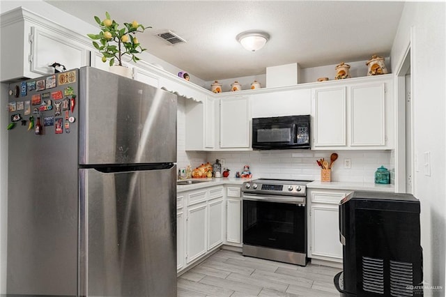 3004 Diaz Ave, Mcallen, TX 78503 - kitchen with appliances with stainless steel finishes, light countertops, decorative backsplash, white cabinetry, and a sink