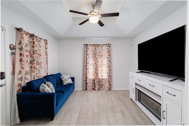 3004 Diaz Ave, Mcallen, TX 78503 - living room with a raised ceiling, ceiling fan, and light wood-type flooring