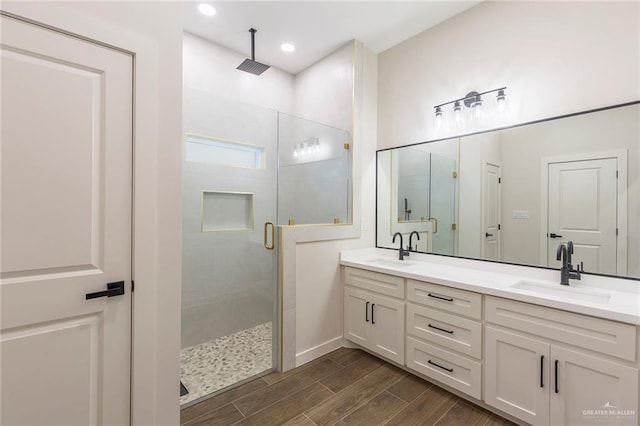 bathroom featuring walk in shower and vanity