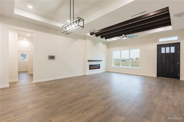 unfurnished living room with ceiling fan