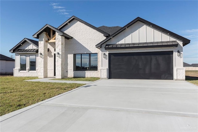 modern farmhouse featuring a garage and a front yard