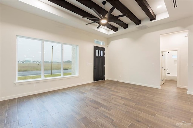 foyer featuring beamed ceiling and ceiling fan