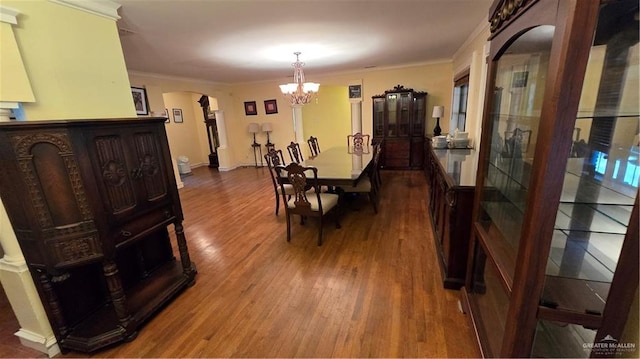 409 Redwood Ave, Mcallen, TX 78501 - dining space with a chandelier, wood finished floors, ornamental molding, and arched walkways