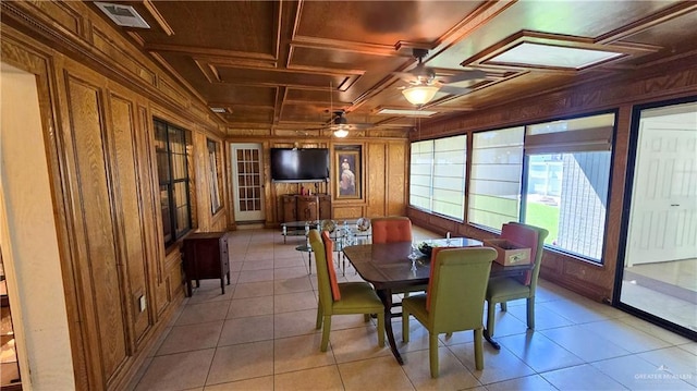 409 Redwood Ave, Mcallen, TX 78501 - dining space with wooden walls, ceiling fan, coffered ceiling, light tile patterned flooring, and crown molding