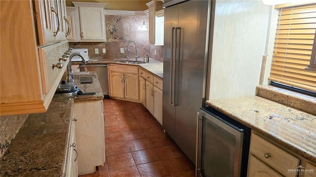 409 Redwood Ave, Mcallen, TX 78501 - kitchen with a sink, dark tile patterned flooring, tasteful backsplash, high end fridge, and beverage cooler
