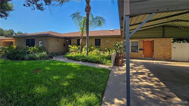409 Redwood Ave, Mcallen, TX 78501 - single story home featuring brick siding, a carport, and a front lawn