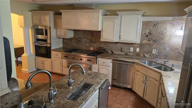 409 Redwood Ave, Mcallen, TX 78501 - kitchen featuring stainless steel appliances, a sink, tasteful backsplash, ornate columns, and light stone countertops