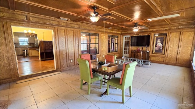 409 Redwood Ave, Mcallen, TX 78501 - dining space featuring a ceiling fan, wooden walls, light tile patterned flooring, coffered ceiling, and ornamental molding