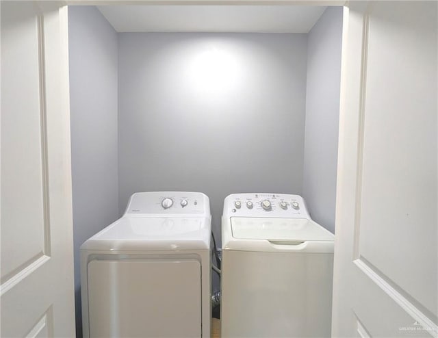 laundry room with washing machine and clothes dryer