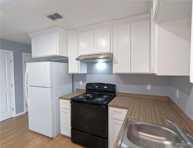 kitchen with white cabinets, white fridge, butcher block counters, and black range with electric cooktop