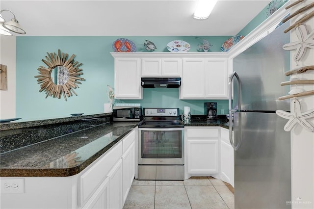 107 E Pike St Unit 2, South Padre Island, TX 78597 - kitchen with appliances with stainless steel finishes, extractor fan, white cabinets, a peninsula, and light tile patterned floors