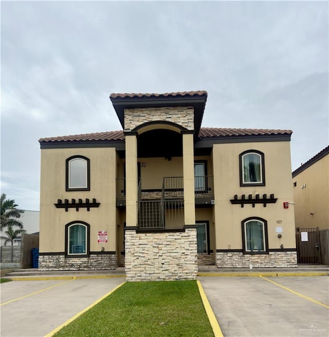 view of property with uncovered parking and fence